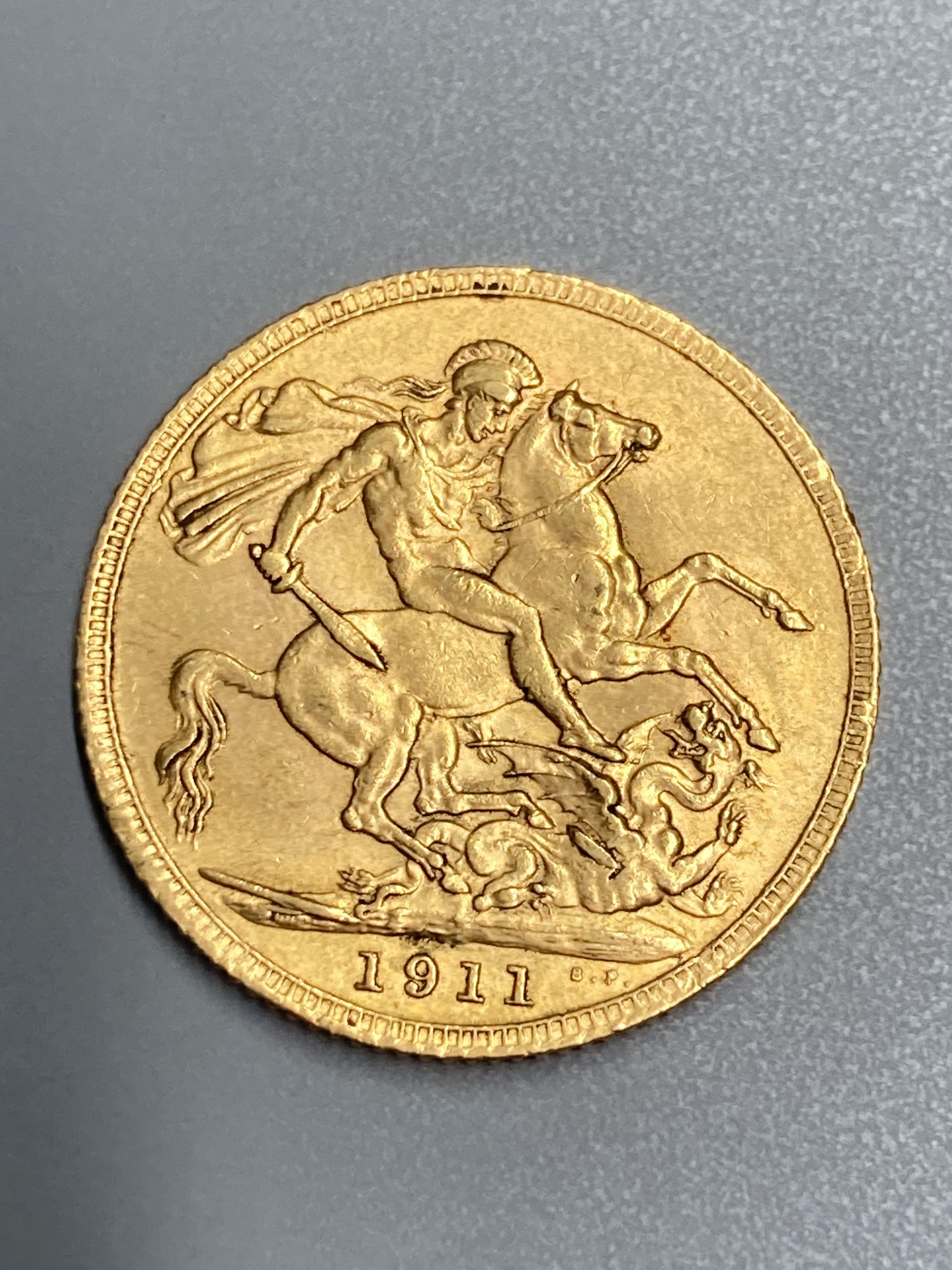 A George V 1911 gold sovereign, GVF.